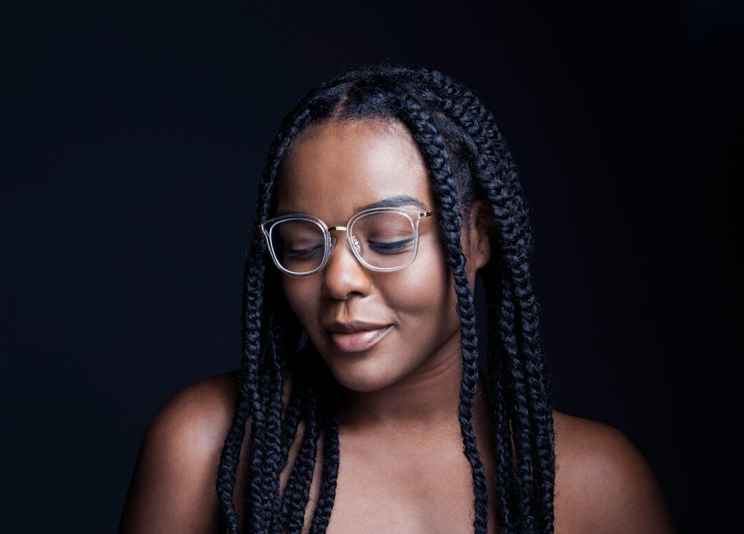 Studio portrait of a woman with glasses smiling