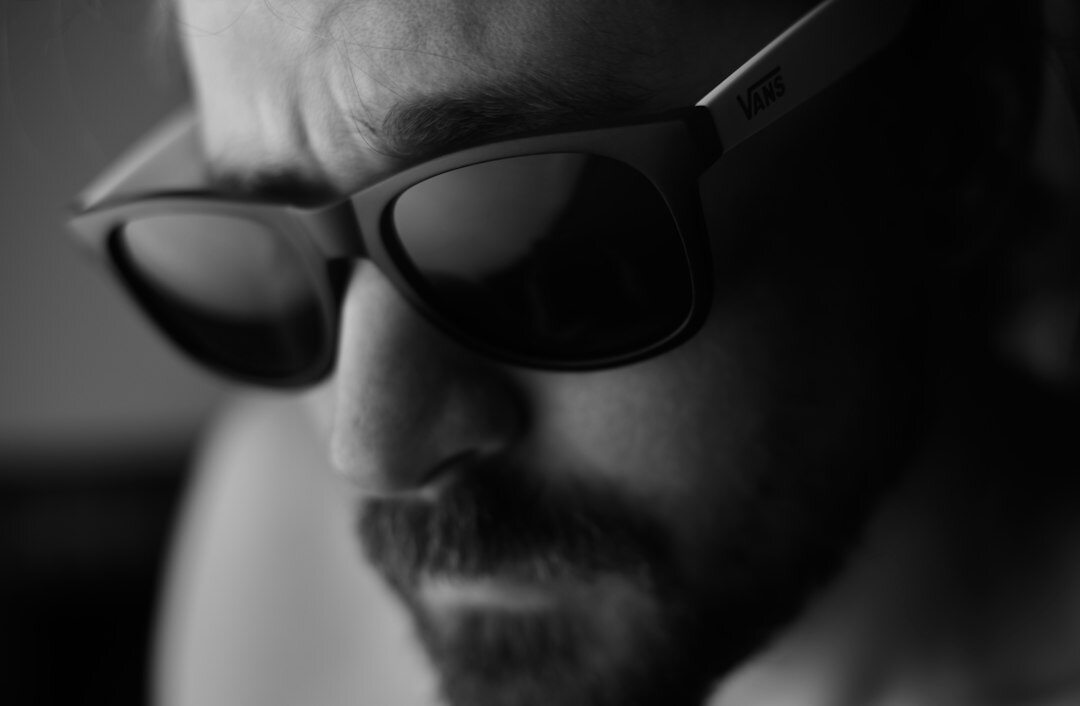Studio portrait of a bearded man with glasses